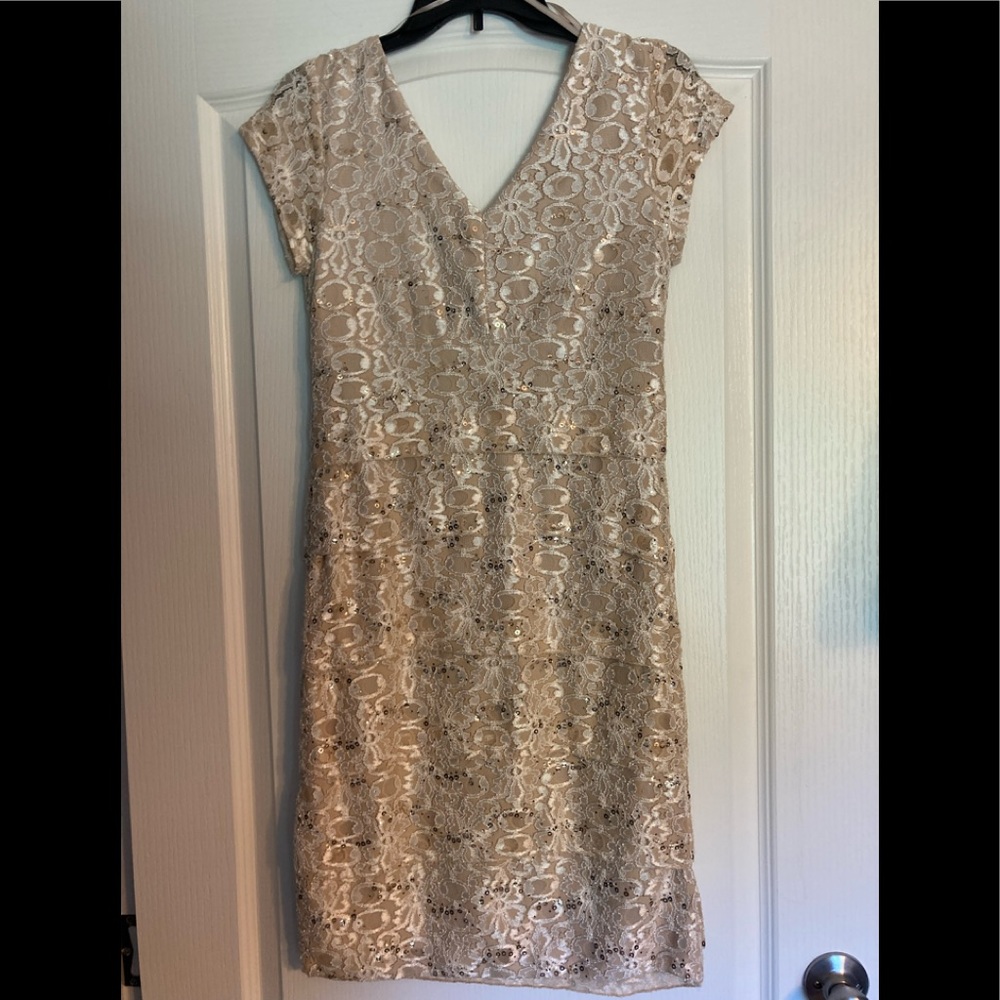 Womens dress. Beautiful. Color is “Natural”. Brand new with tags. Never worn!